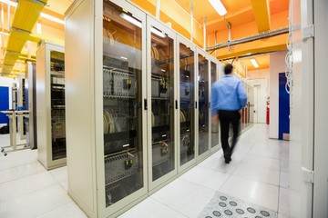 Technician walking in server room