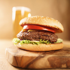 homemade hamburger with beer on background