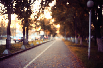 Fototapeta na wymiar blurred background path in autumn city park