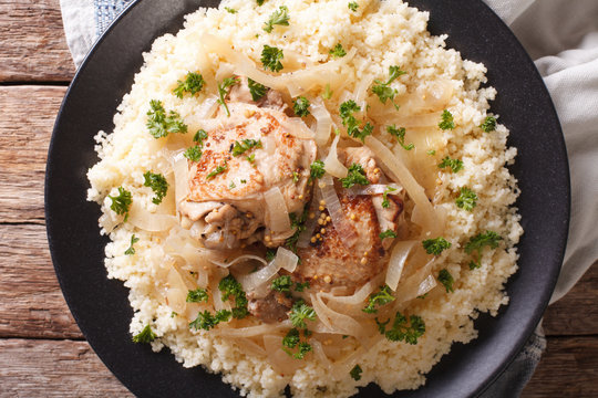 Senegalese cuisine: chicken Yassa with couscous and onions close-up. Horizontal top view