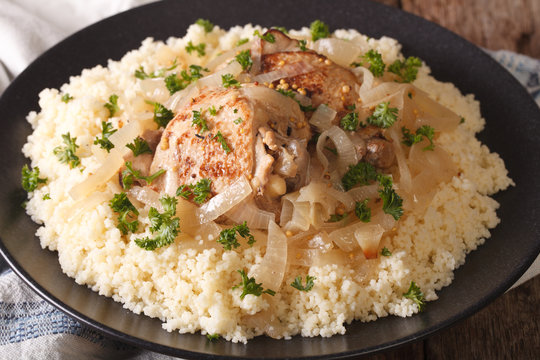 West African food: Chicken Yassa and couscous with onions macro. horizontal
