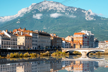Morning cityscape view with mountains, river and bridge in Grenoble city on the south-east of France - obrazy, fototapety, plakaty