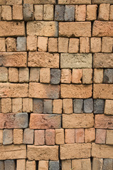 A stack of colorful old clay bricks