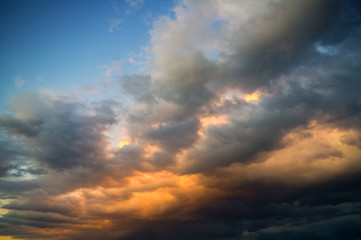 Naklejka na ściany i meble storm clouds on sunset sky