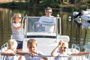 family enjoying a summer day on a boat