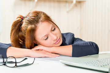 tired business woman asleep at his desk, close-up portrait