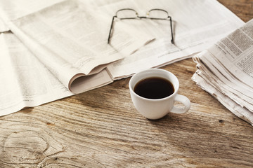 Newspaper with coffee on table