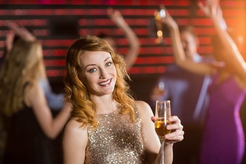 Portrait of young woman holding a glass of champagne