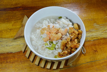 boiled rice with minced pork and dried prawn topping fried garlic oil on bowl