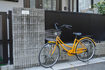 Yellow classical bicycle parked on the street
