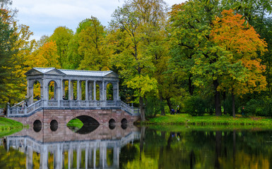 Autumn landscape in the Park with a marble bridge