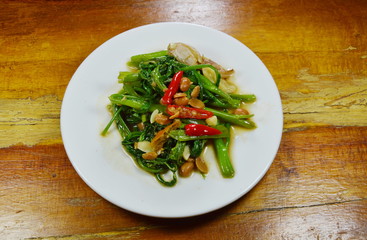 stir fried morning glory with chili and soy bean paste on dish