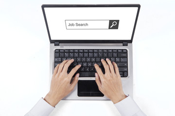 Hand typing job search on the laptop