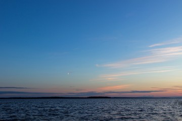 Beautiful tranquil summer sunset on the Onega lake, Karelia, Russia