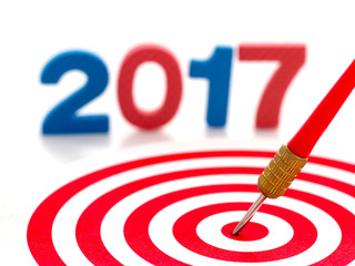 2017 year goal, red bullseye dart arrow hitting target center dartboard and blur two thousand...
