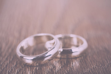 pair of wedding rings on a wooden background Vintage Retro Filte