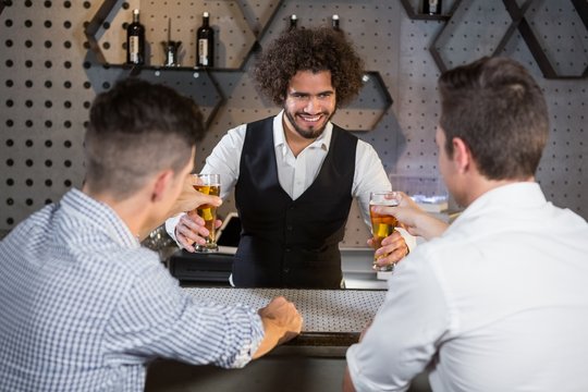 Bartender serving beer to customers