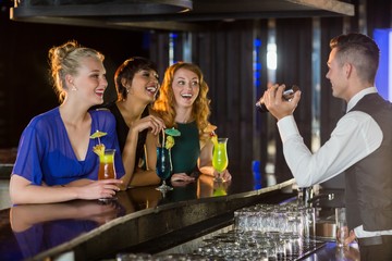 Waiter interacting with beautiful women