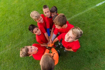 Tuinposter Boys celebrating after soccer match © Dusan Kostic