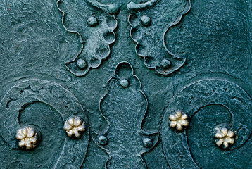 embossed metallic green-blue background with baroque details and with buttons and metal gold ...