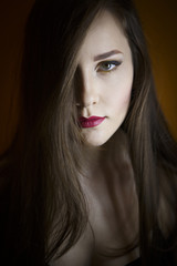 Portrait of a beautiful young girl on a dark background