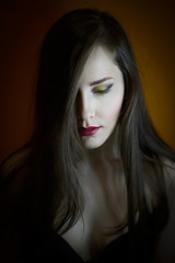 Fototapeta premium Portrait of a beautiful young girl on a dark background