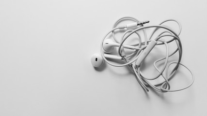Tangled headphone cable on white background isolated.