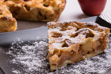 apple pie slice on black plate