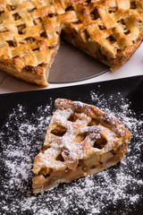 apple pie slice on black plate