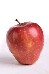 red apple on white table