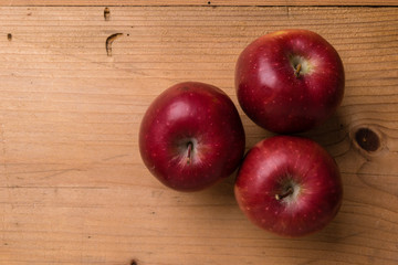 red apple on wooden table