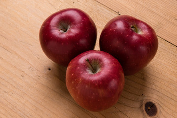 red apple on wooden table