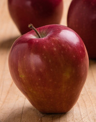 red apple on wooden table