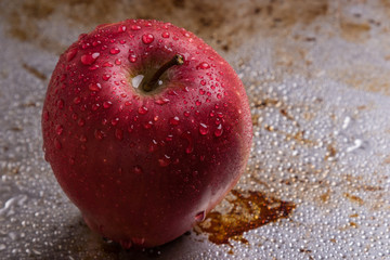 red apple on steel plate