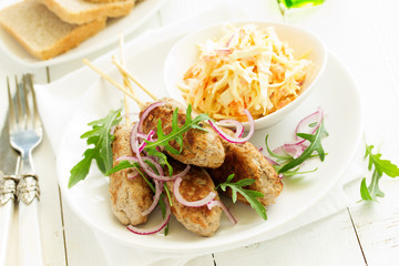 Kyufta kebab with salad close-up.