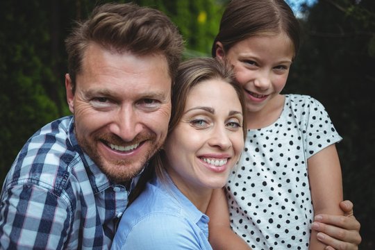 Portrait of happy family smiling in park