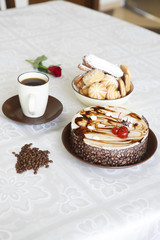 Portrait of a slice of cake with tea and a rose on a table
