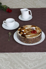Portrait of a slice of cake with tea and a rose on a table