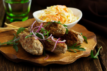 Kyufta kebab with salad close-up.