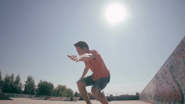 Skateboarder doing tricks ina city. Slow motion, 100 fps. HD