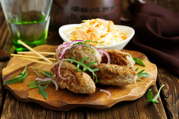 Kyufta kebab with salad close-up.