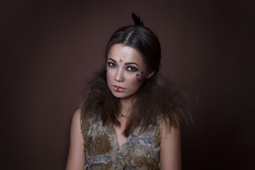 Portrait of a beautiful girl in the style of Indian America in a fur vest