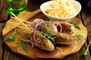Kyufta kebab with salad close-up.
