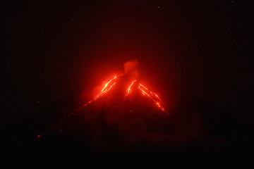 Night view of eruption Klyuchevskoy Volcano, current lava flows on slope of volcano. Eurasia, Russian Far East, Kamchatka Peninsula, Klyuchevskaya Group of Volcanoes.