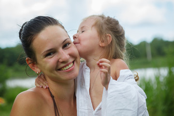 Portrait of mother and daughter outdoors forest river grass