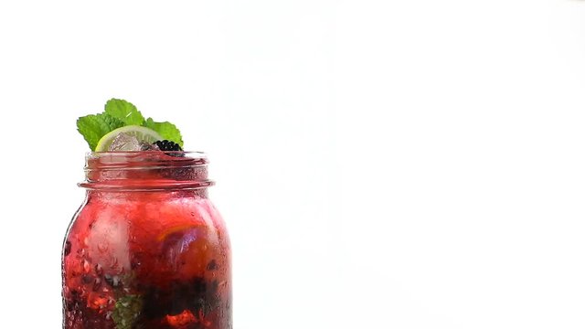 Hand fruit made lemonade rotates on a white background