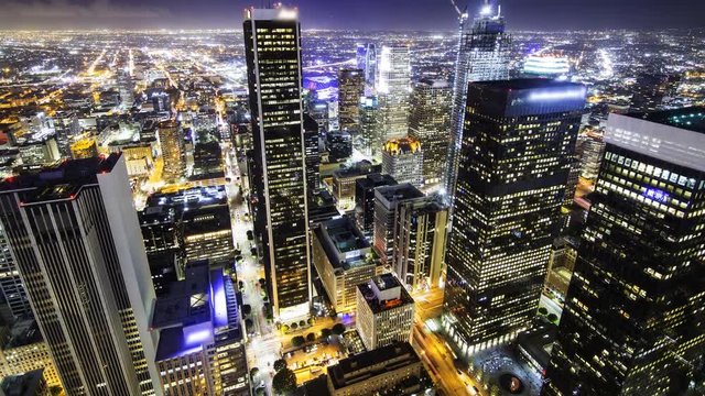 Time lapse overview with tilt up motion of city lights in downtown Los Angeles at twilight