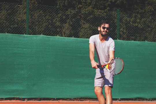 Male tennis player serving the ball