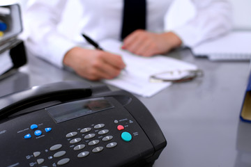 Fototapeta premium Bookkeeper or female financial inspector making report, calculating or checking balance. Internal Revenue Service checking financial document. Audit concept.