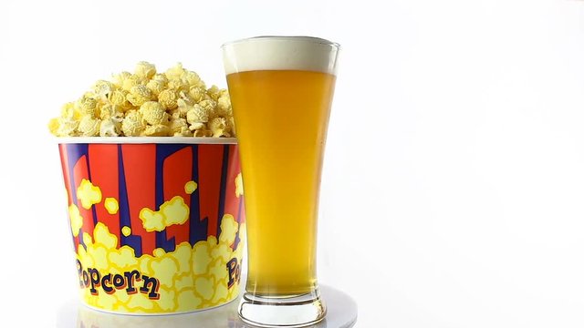 Bacon popcorn with beer rotates on a white background. Medium shot